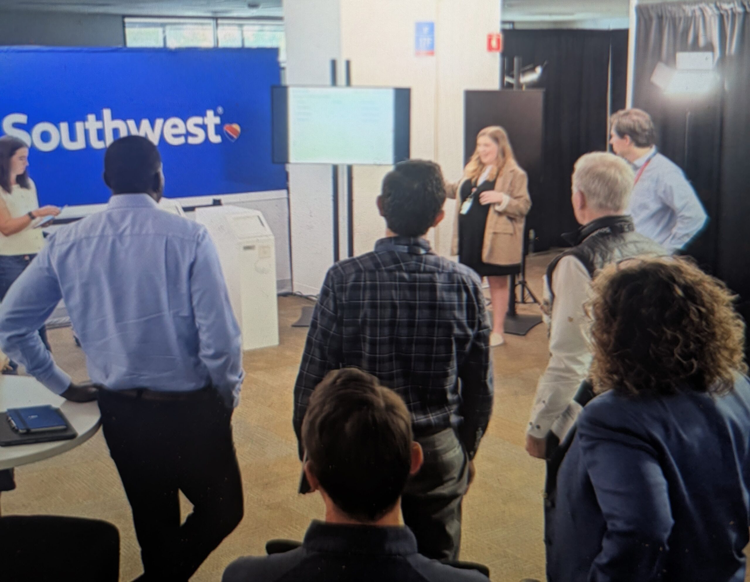 Taylor is speaking to Southwest C-suite about how the kiosk will work for seat assignments ahead of the January 2026 launch